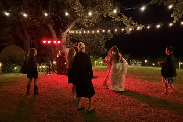 Outdoor wedding sound system rental with string lights at night in Minnesota